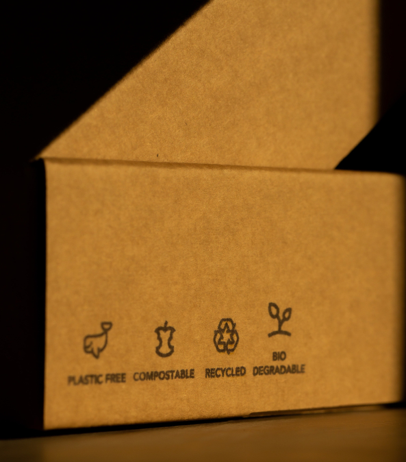 brown cardboard box with recycling symbols_vertical